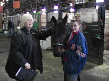 Standardbred Fan Club volunteers at the race track readying a horse to be rescued